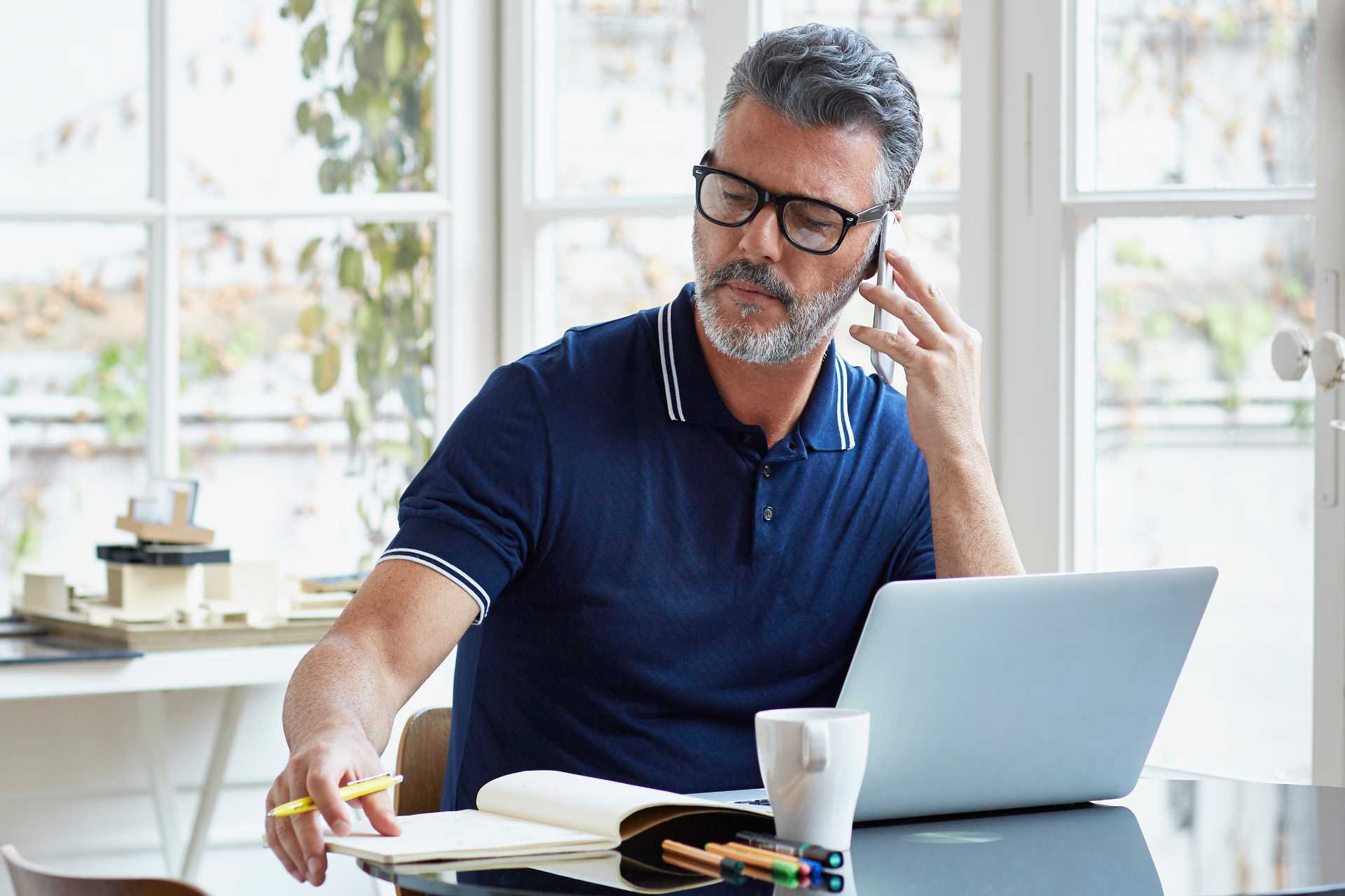 Mature man on laptop and phone