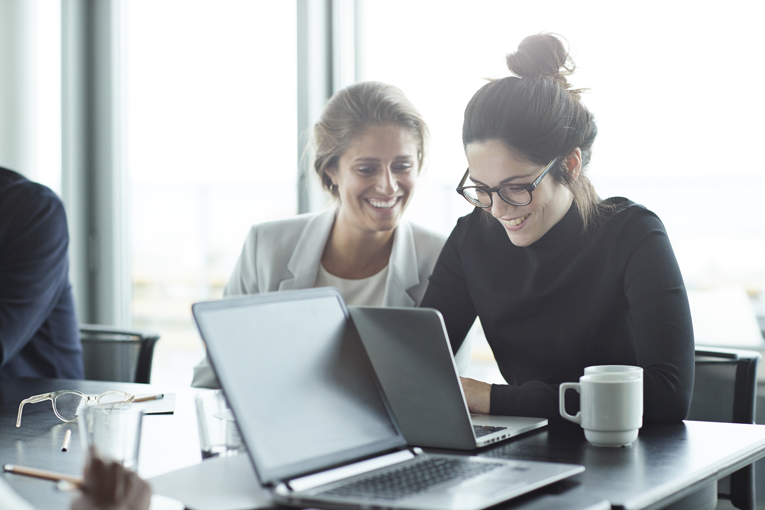 Female colleagues discussing over a coffee.