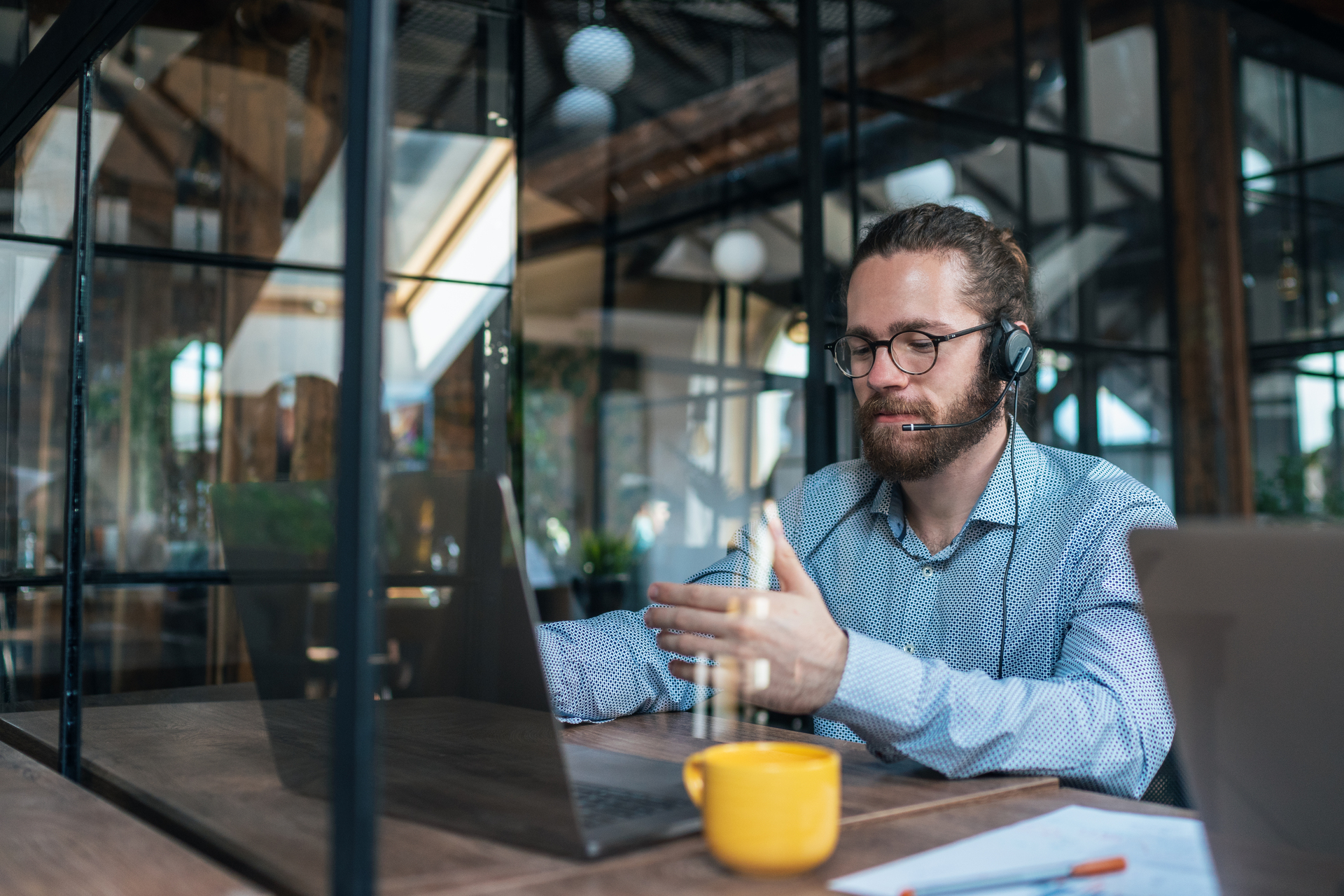 Young businessman at modern office having video call