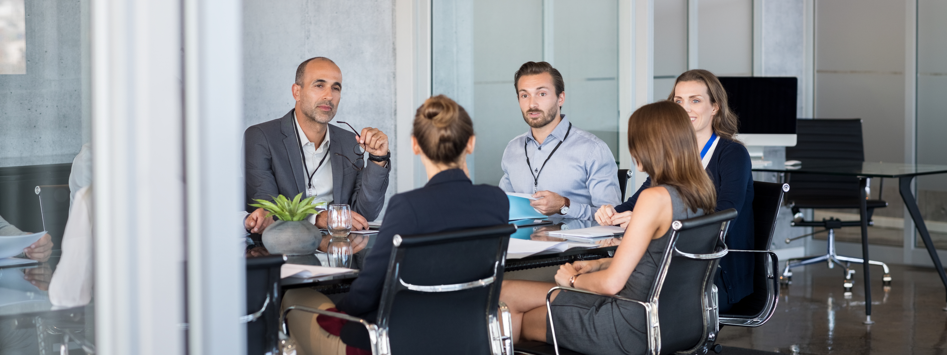 Business people sitting in boardroom and working together at new strategy plan. Group of leader and businesspeople in a meeting at office. Senior executive with his team working in a conference room.