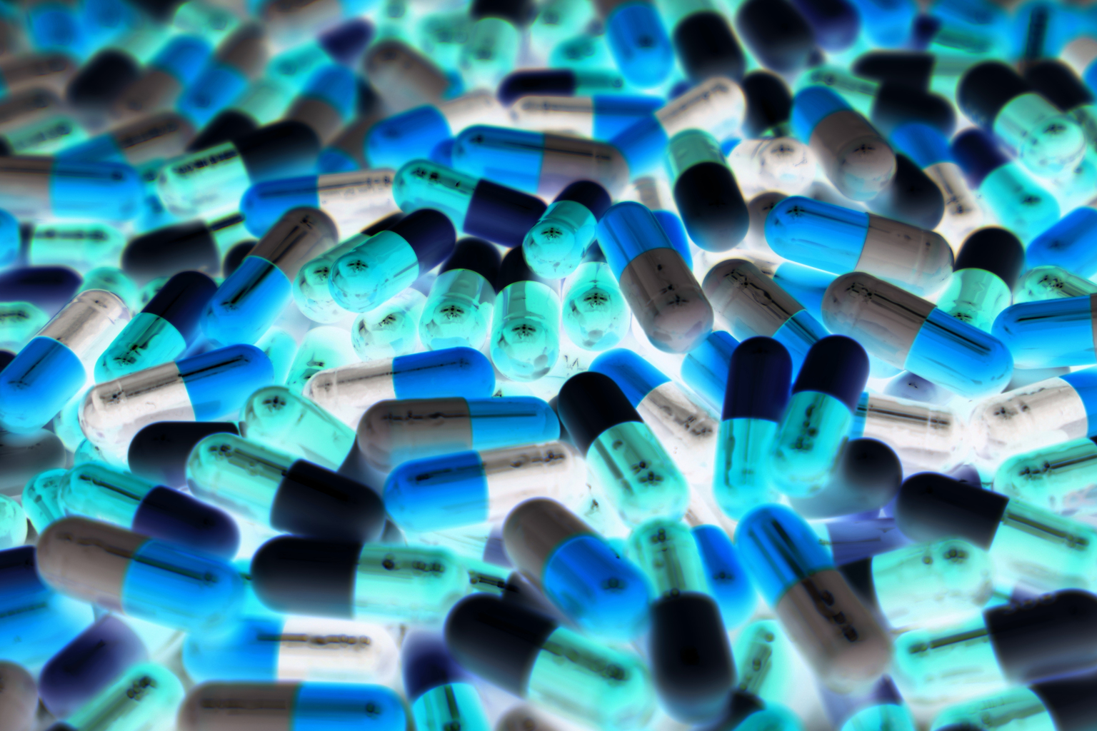 Pile of blue, green, and white color of capsule pills with modern design light
