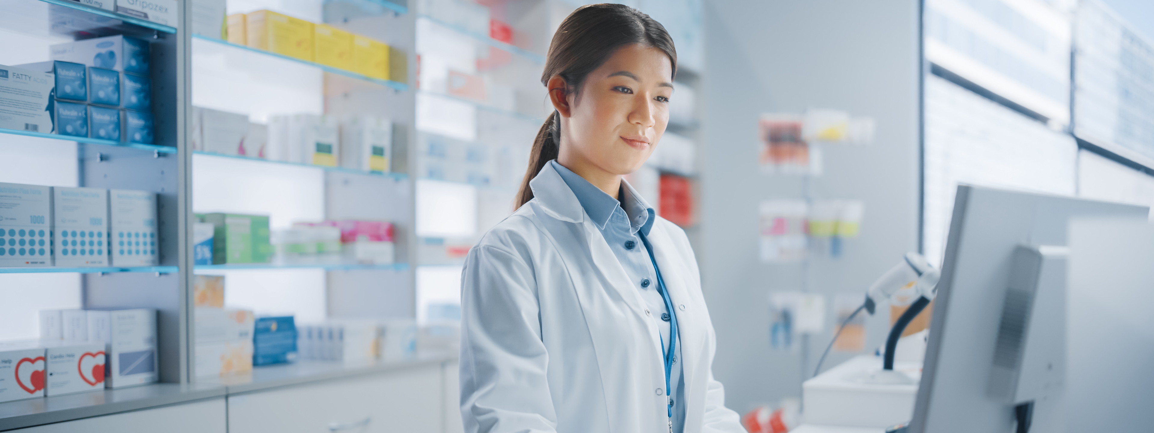 Pharmacy Drugstore: Asian Pharmacist Uses Checkout Counter Computer, Does Inventory Checkup, Online Prescription of Medicine Packages, Drugs, Vitamin Boxes, Supplements, Health Care Products