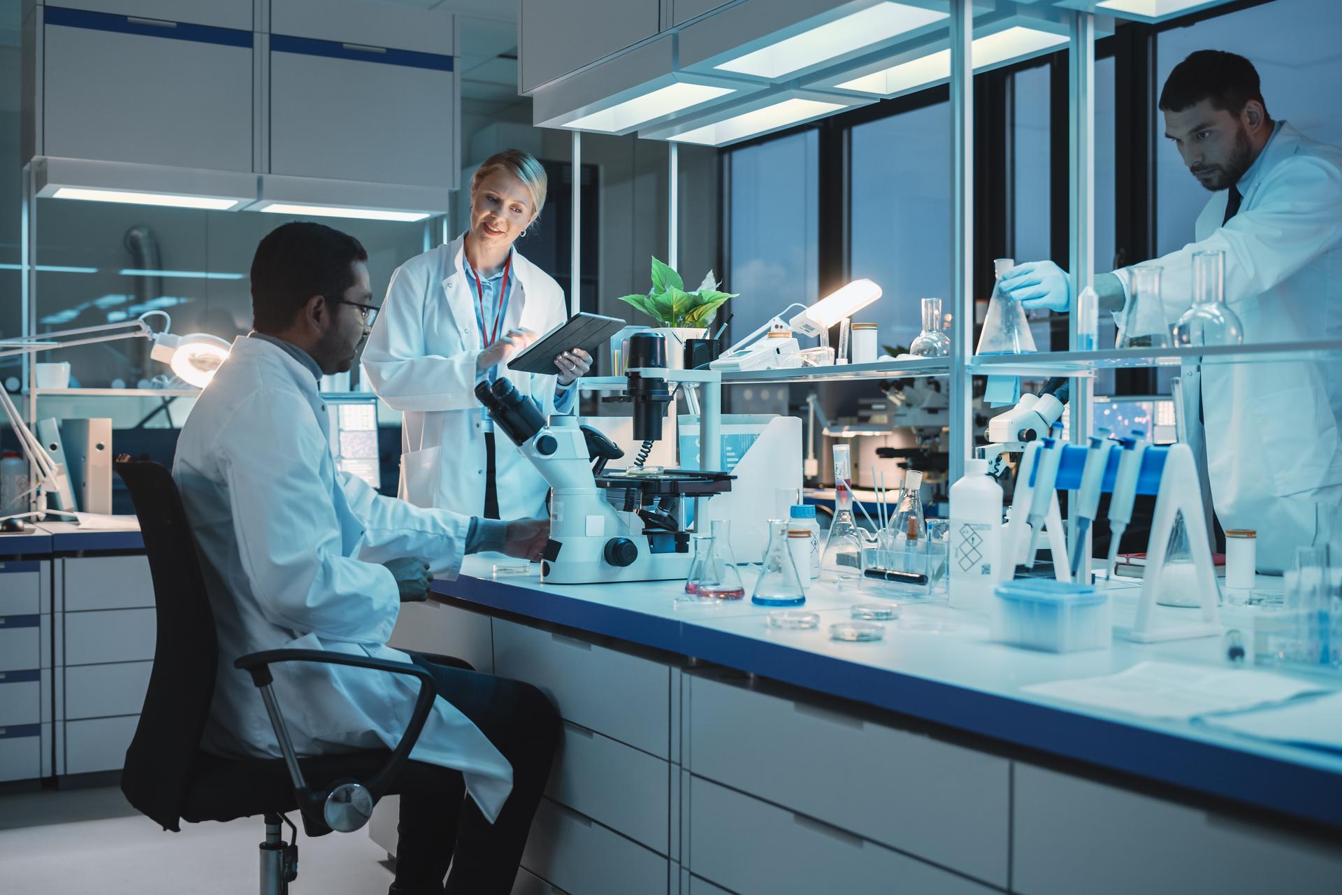 Three scientists in a lab working on experiments