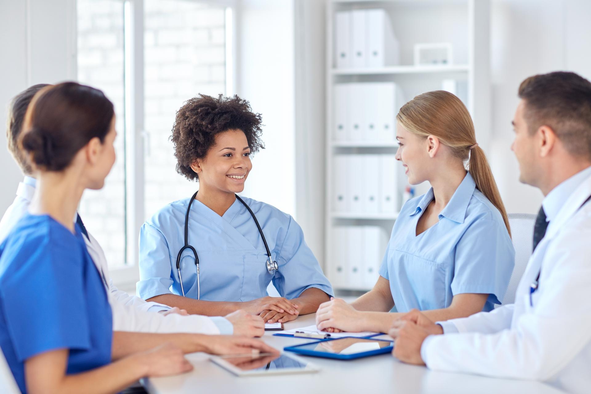 Group of happy doctors meeting at hospital office