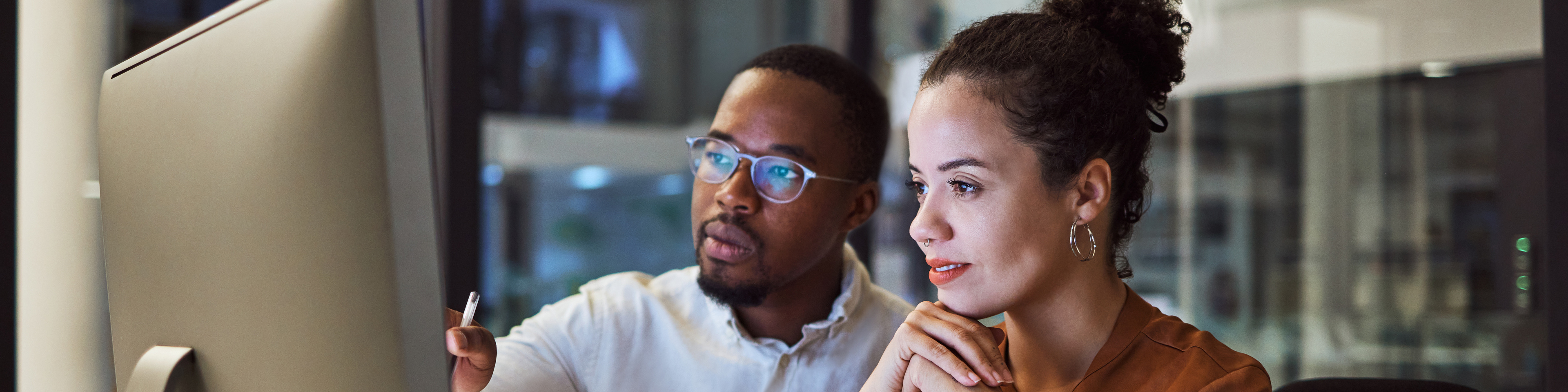 Two people looking at screen