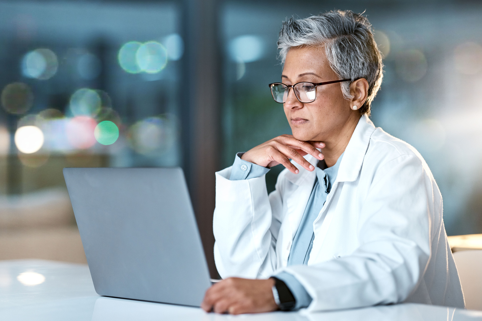 Doctor looking at a laptop.