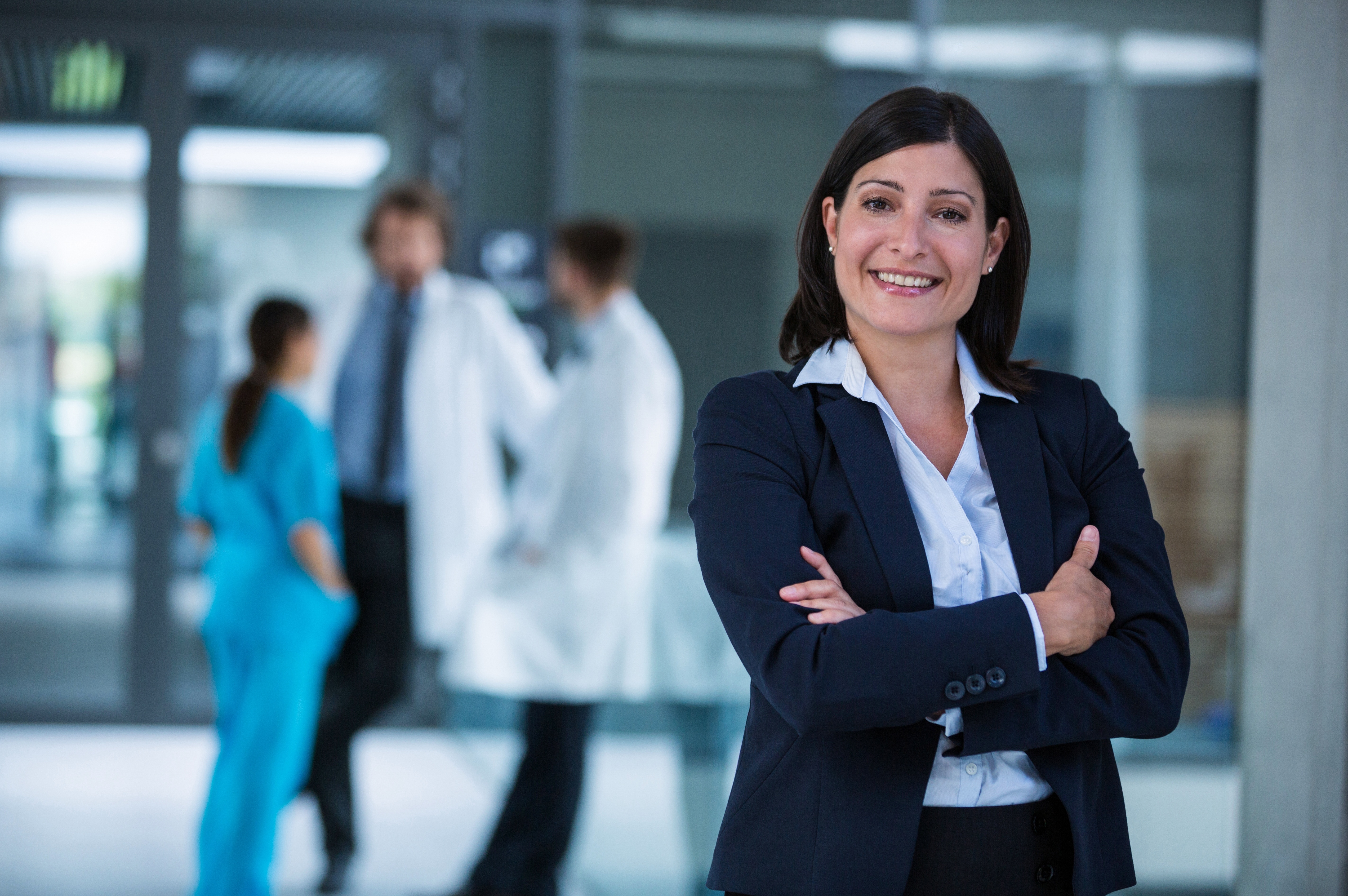 Hospital administrator standing in front of hospital