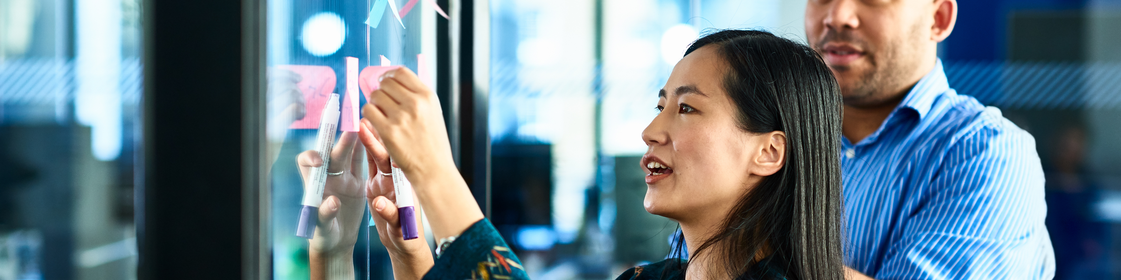 A female coworker figuring out strategies on post-it notes