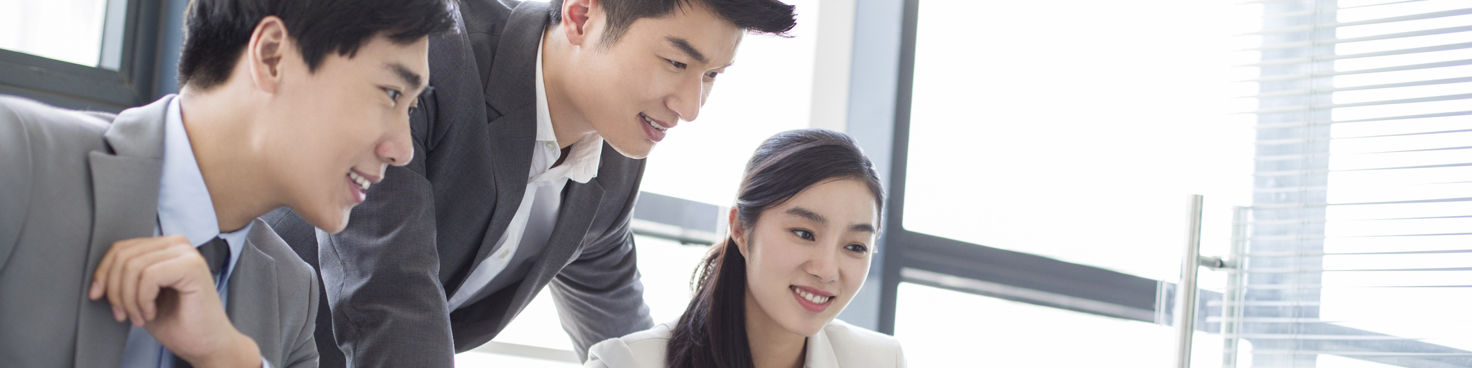 Young Asian business people in meeting working together on laptop