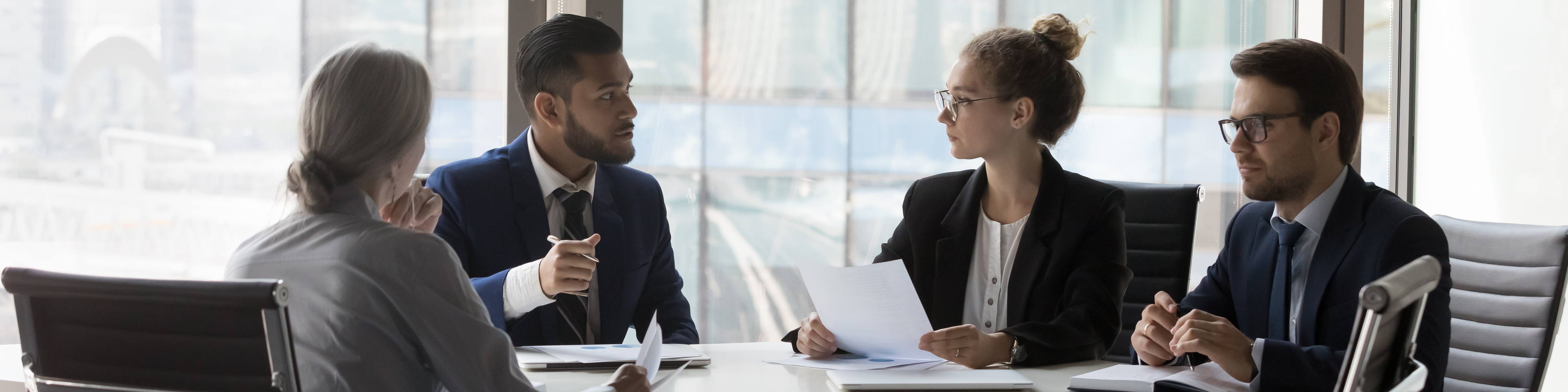 Business partners negotiating, discussing terms on meeting in office