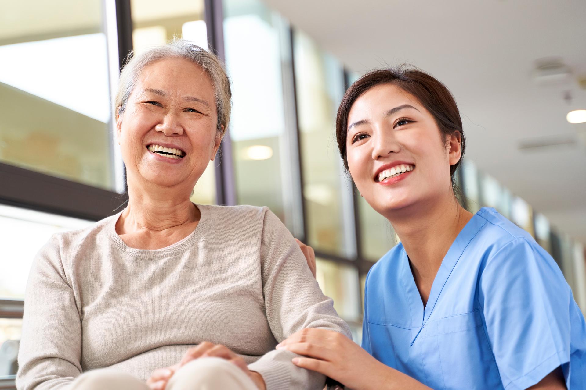 Nurse and senior patient smiling at the camera