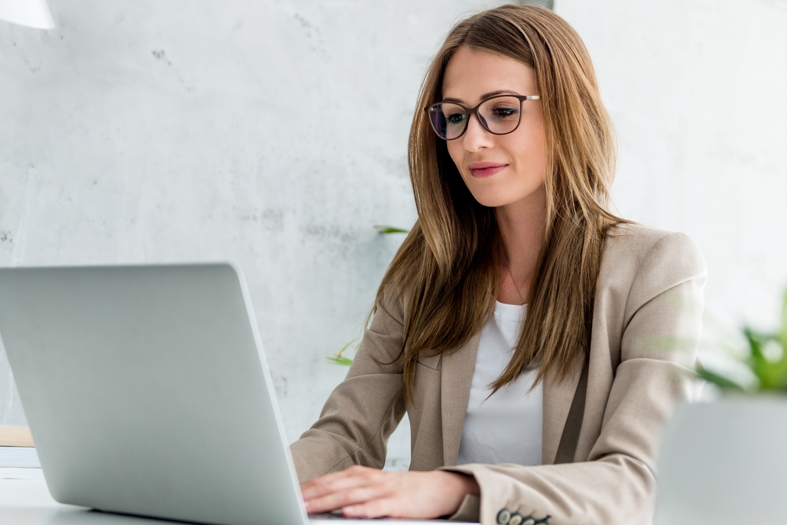 Businesswoman typing on laptop