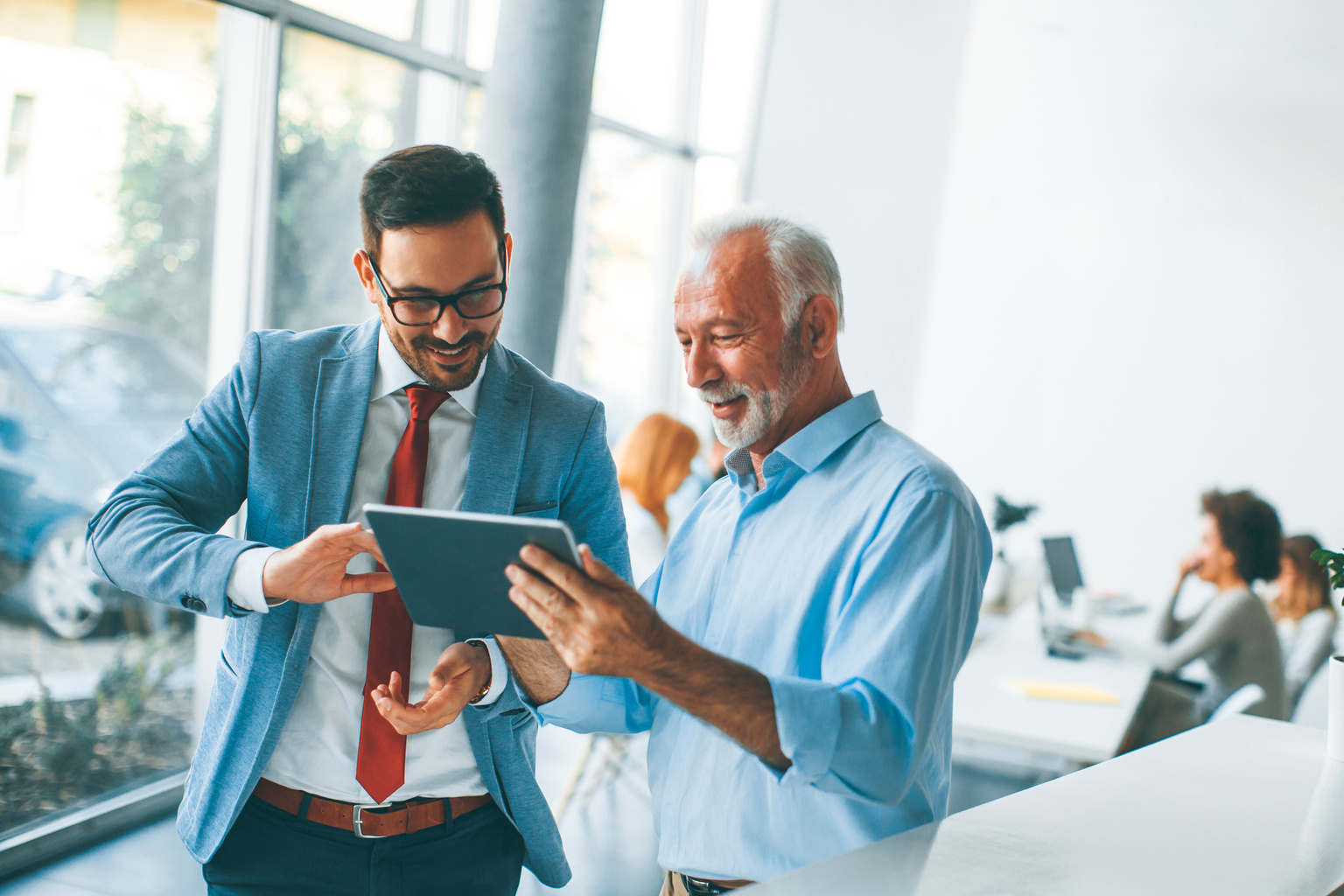 Businessmen with digital tablet in office