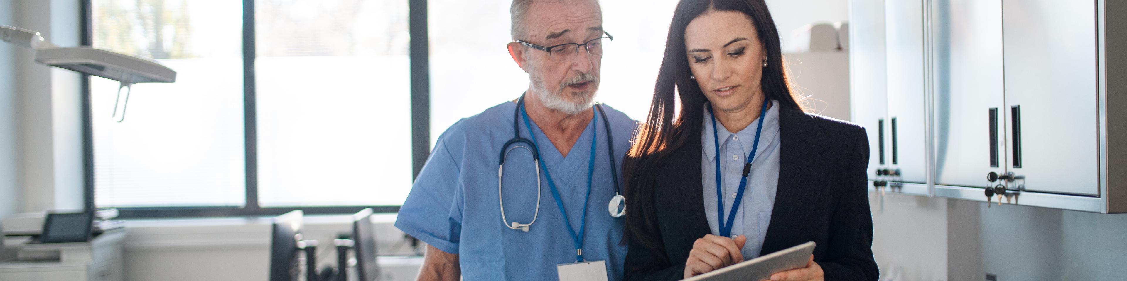 Young pharmaceutic seller explaining something to doctor in hospital