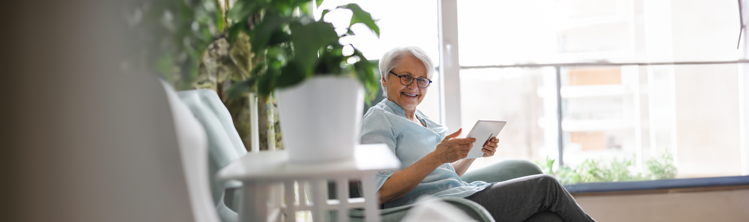 Senior woman using a digital tablet at home