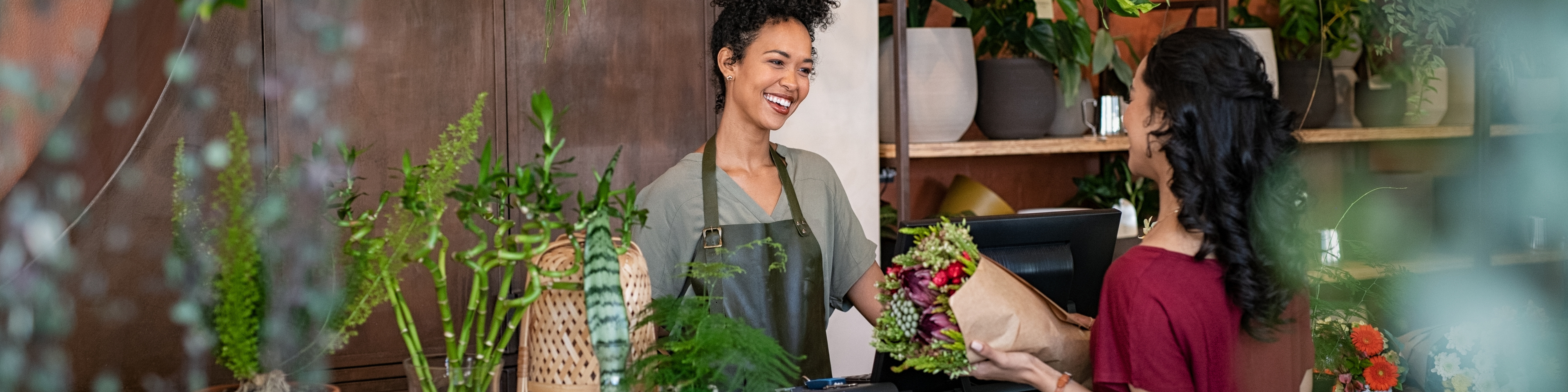 florist-selling-plants-and-flowers-to-client.jpeg