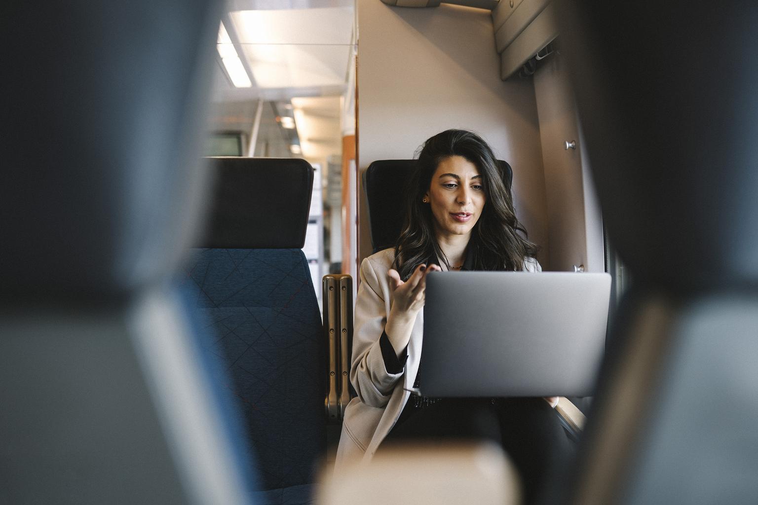 Woman working on laptop from a plane
