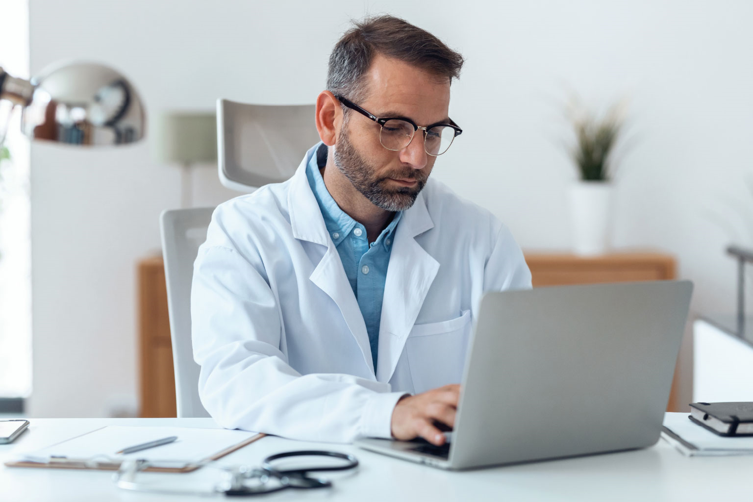 doctor looking at a laptop