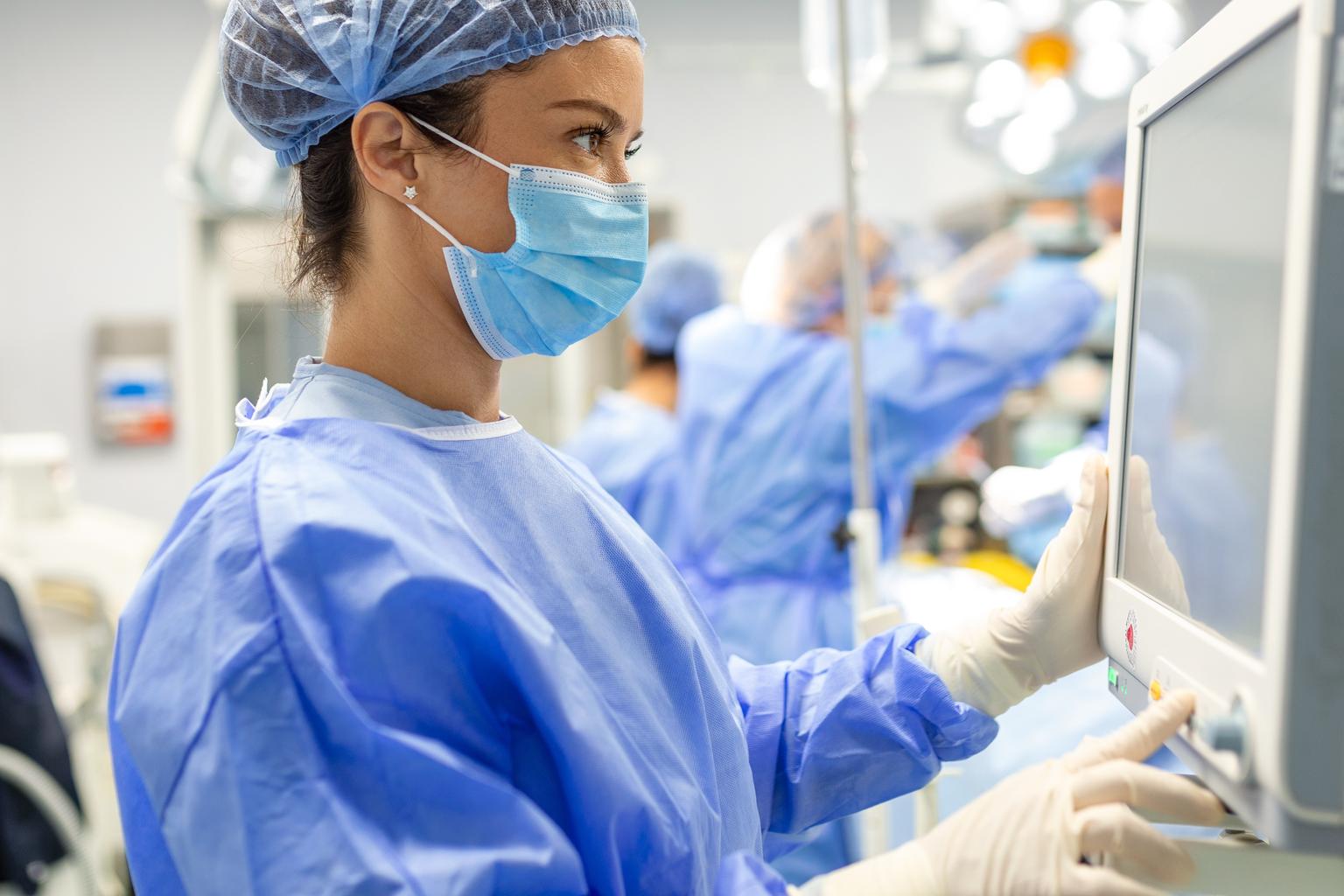 Surgeon looking at medical monitor during surgery