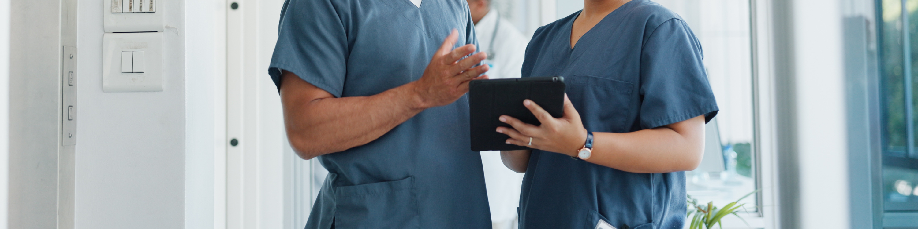 Nurses planning, collaborating, discussing with a tablet