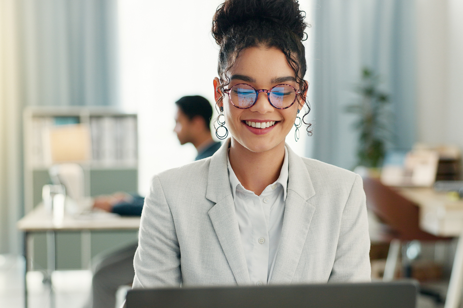 Businesswoman looking at her computer and smiling