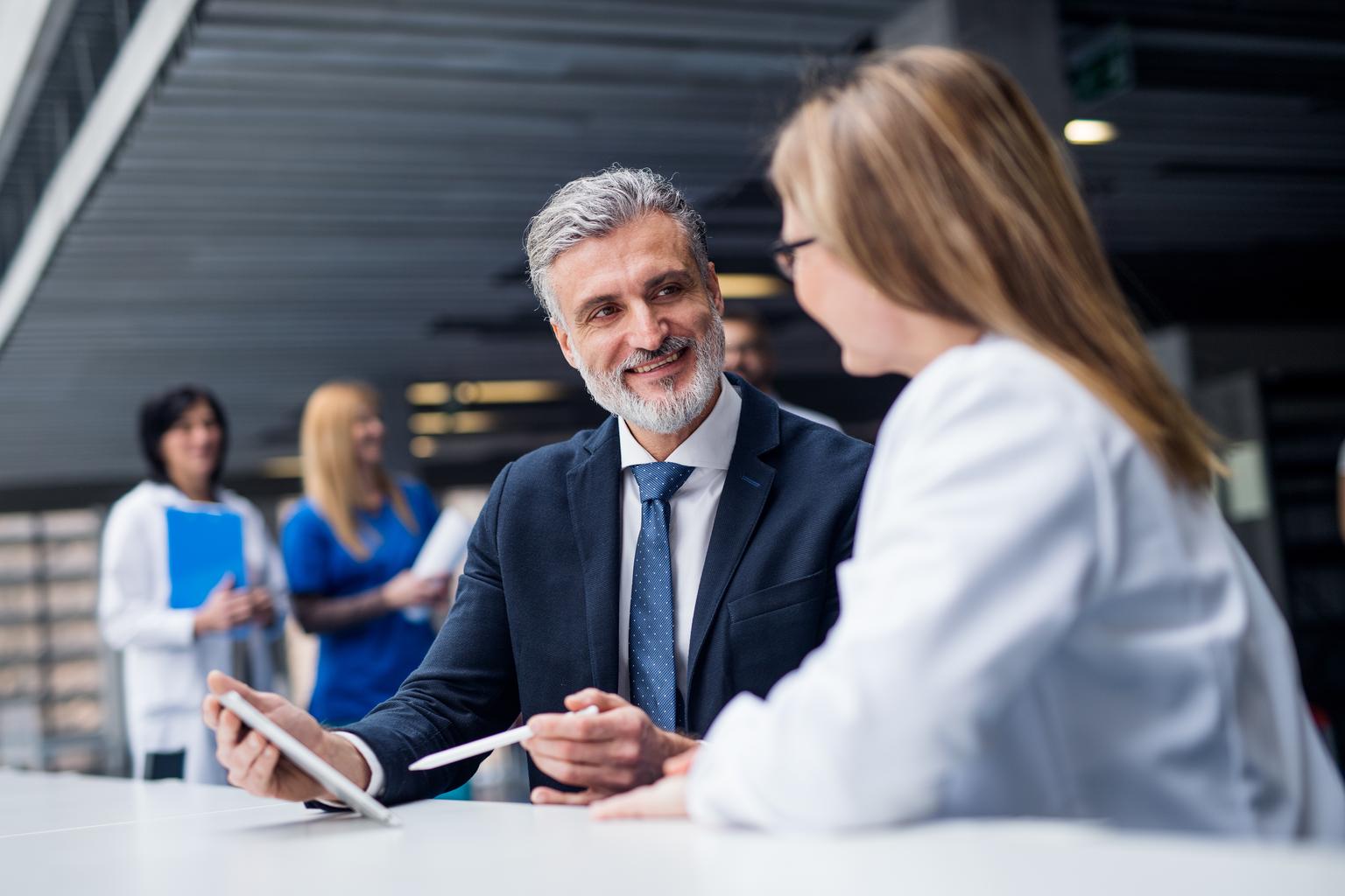 Hospital executive with doctor and tablet