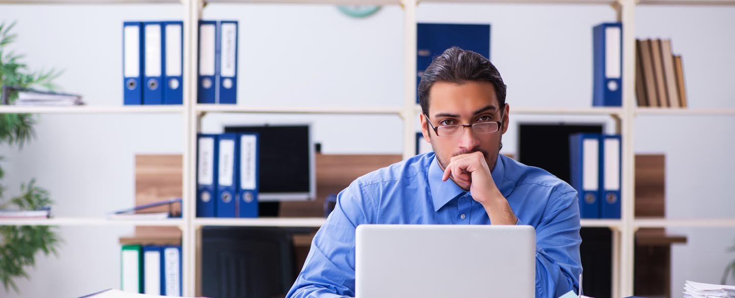 banking employee trying to revive a UCC filing at a desk