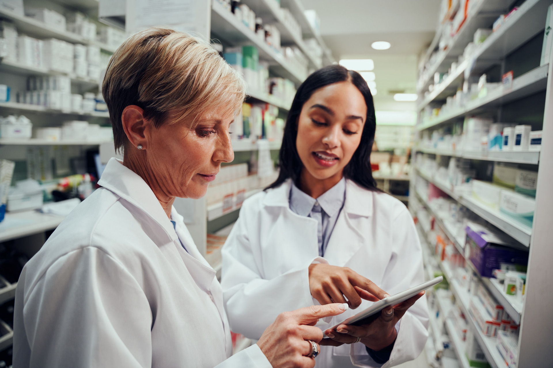 Two pharmacists looking at tablet