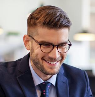 Business man smiling and working on Laptop