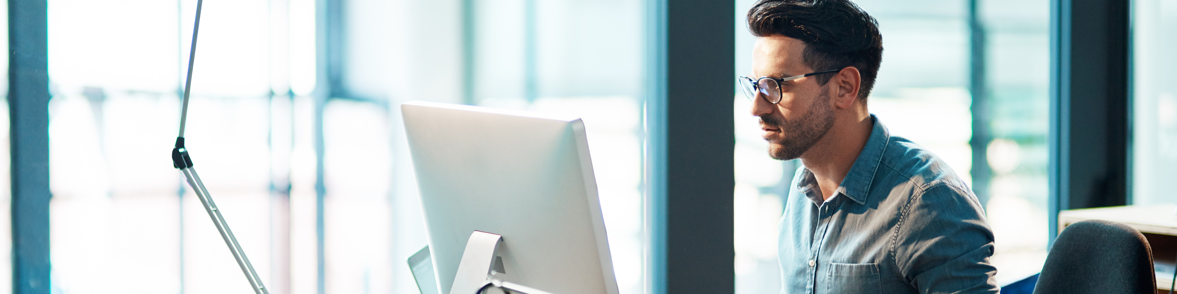 young-businessman-using-a-computer-at-his-desk