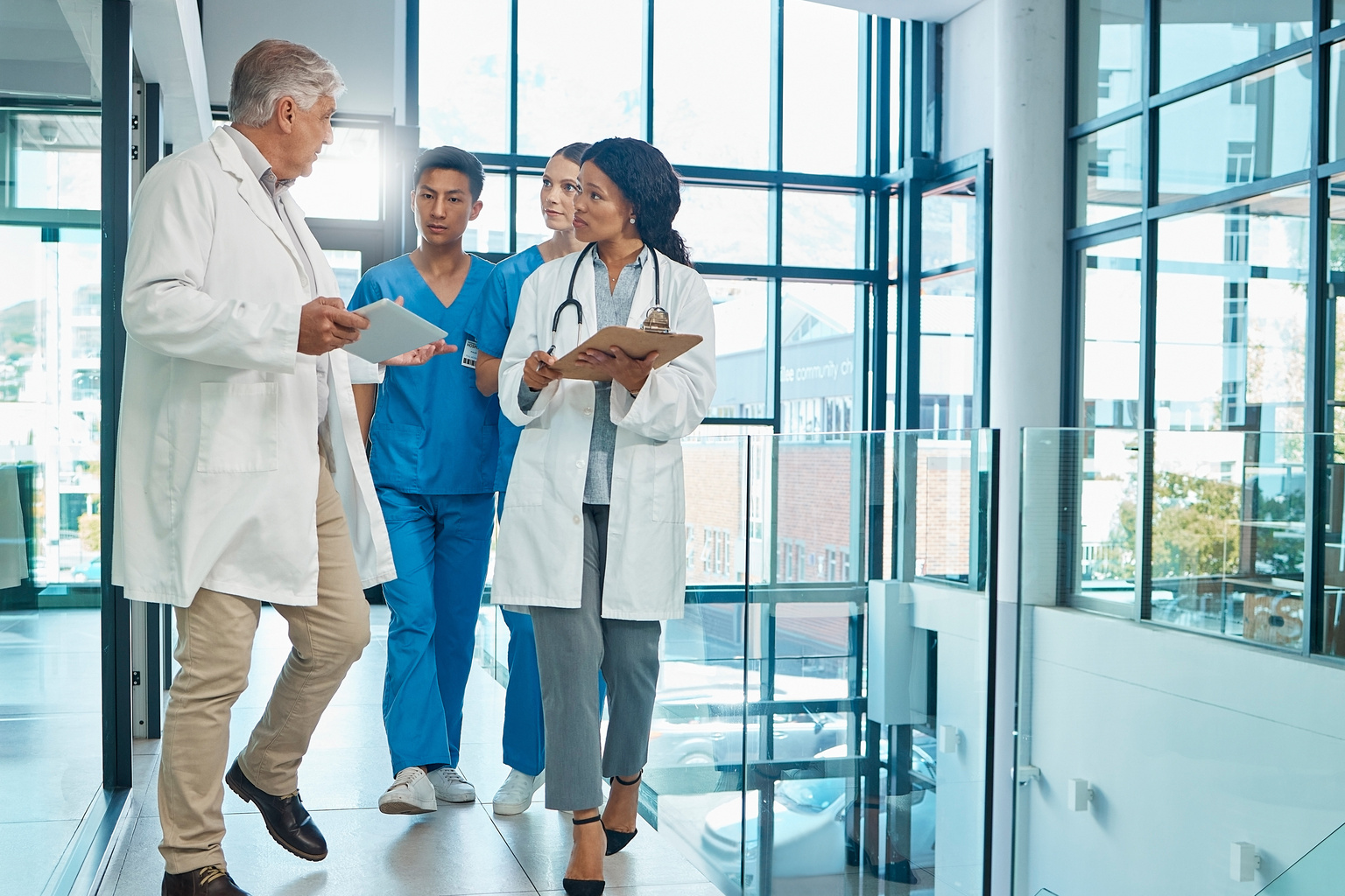 Medical team, doctors and nurses walking together discussion, planning or strategy