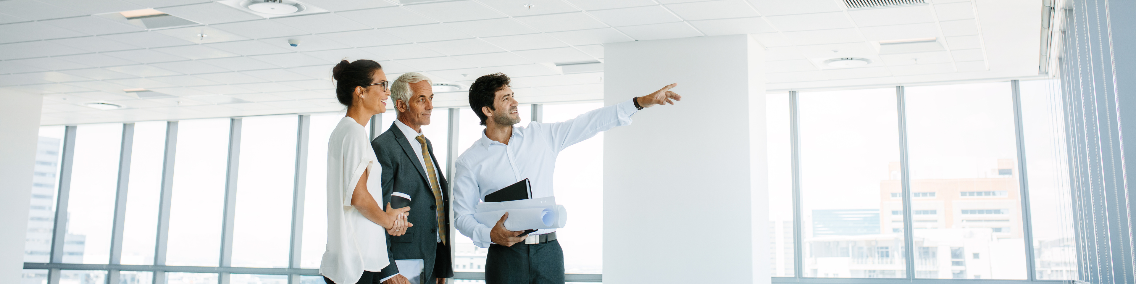  Real estate broker showing office space to clients 