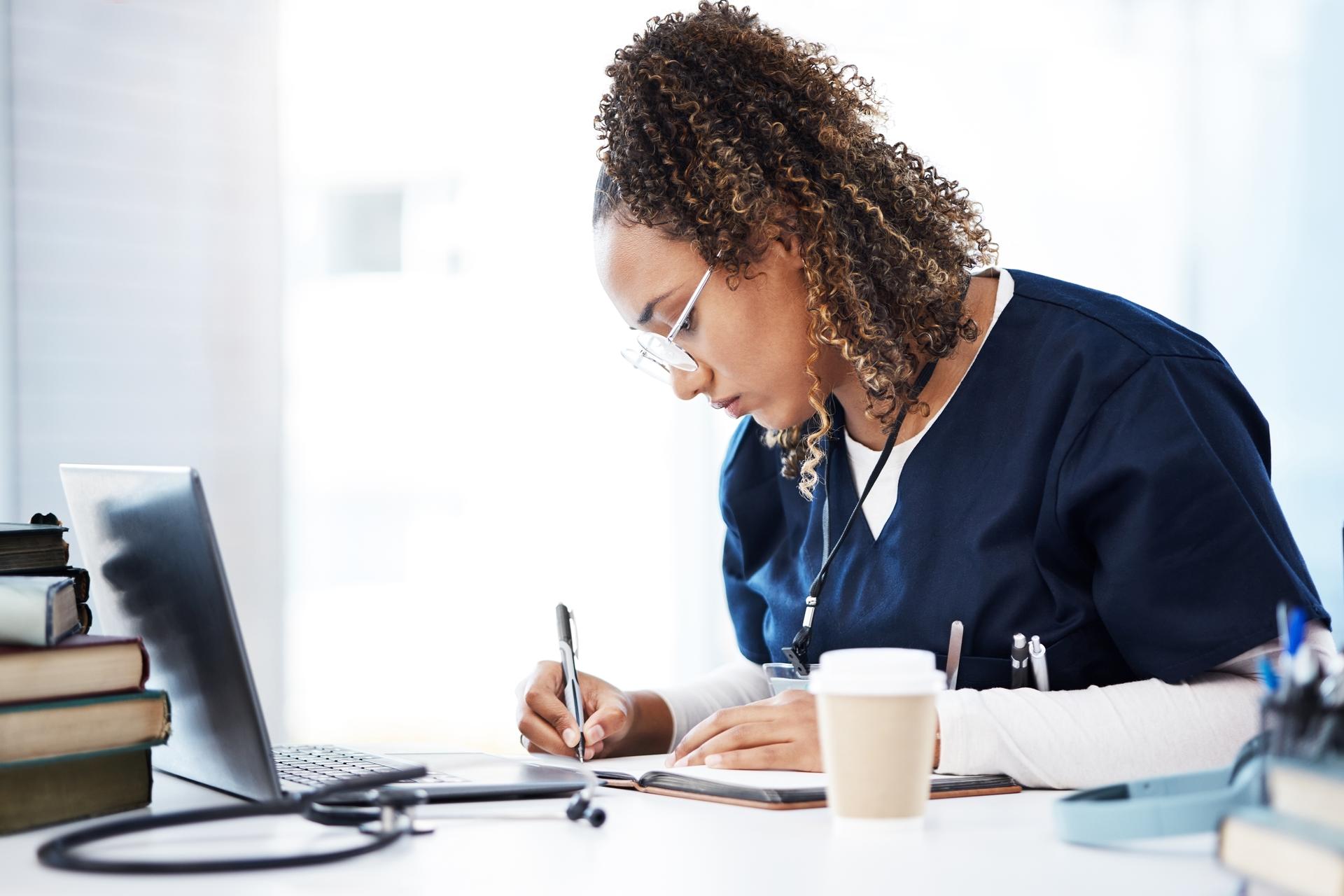 Nursing student using laptop to study for NCLEX-RN