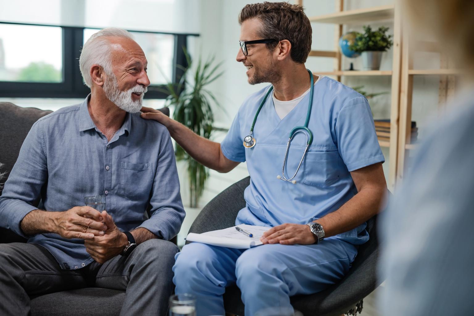 Male doctor visiting senior male patient