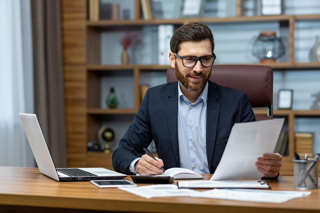 man with glasses looking at document