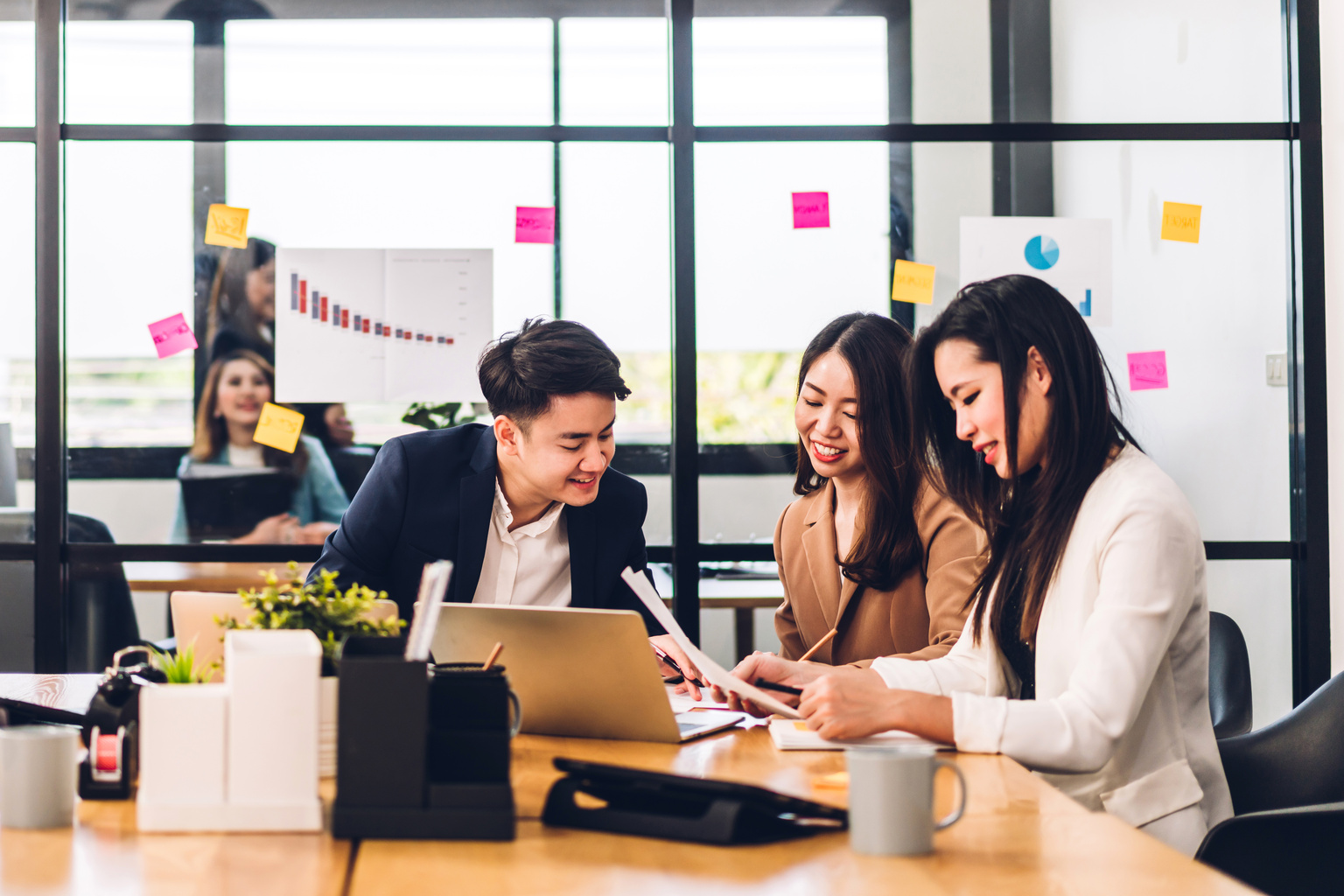 Business people planning and brainstorming with laptop