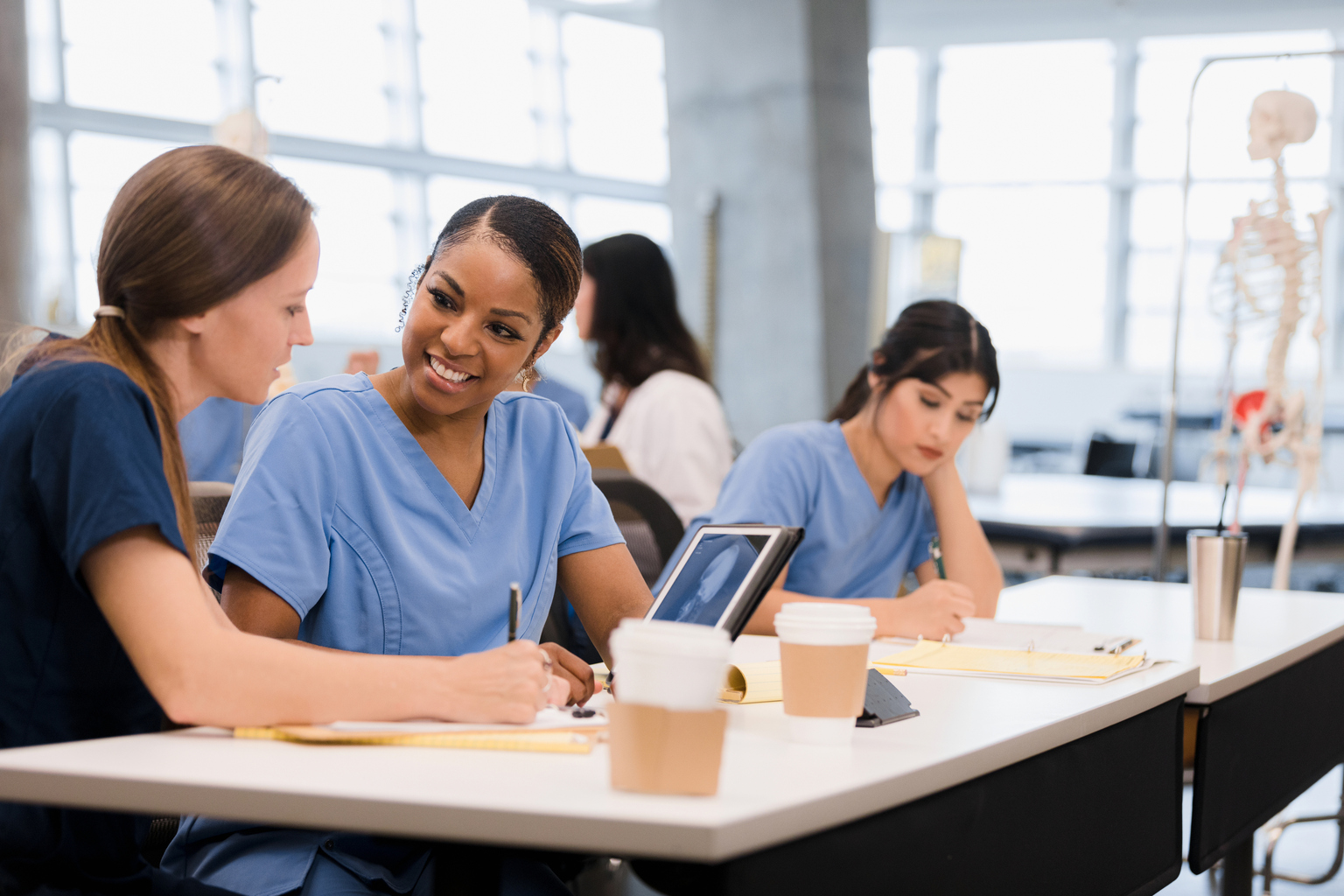 Two nursing student studying together with a tablet.