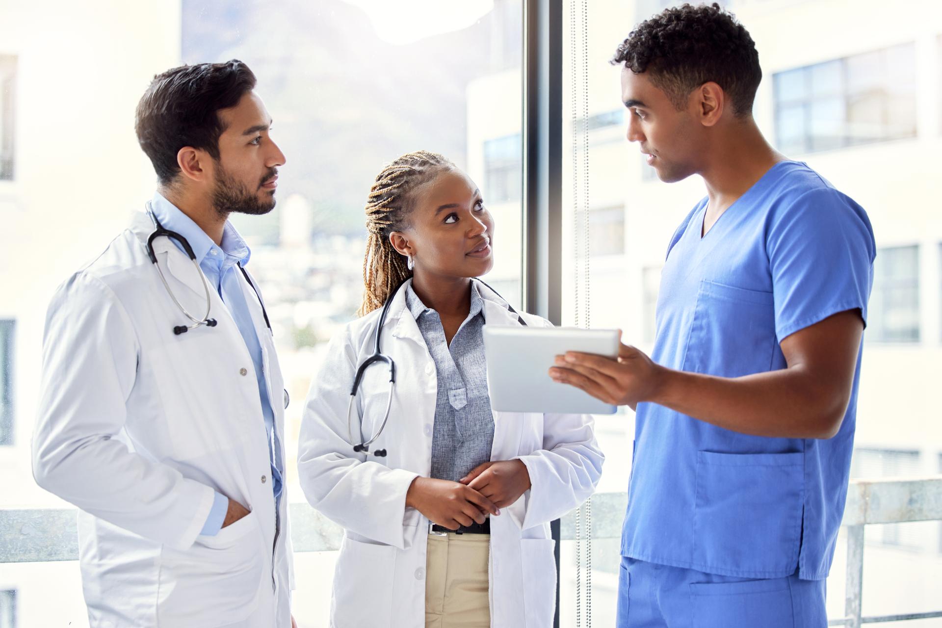 A group of doctors using a digital tablet at work