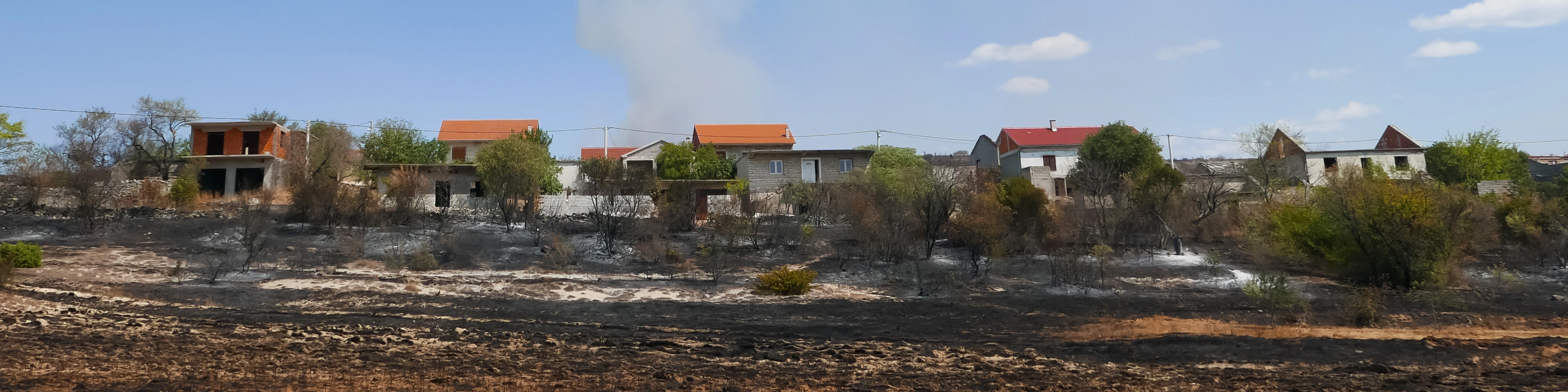 Wildfire threatening the households, burned crops near houses