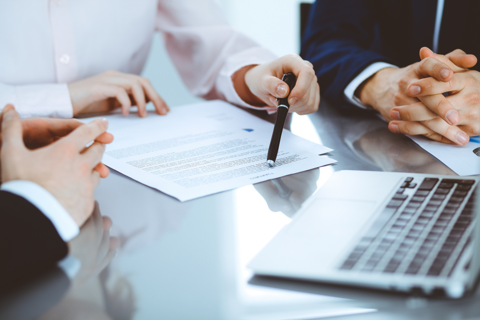 Group of business people and lawyers discussing contract papers