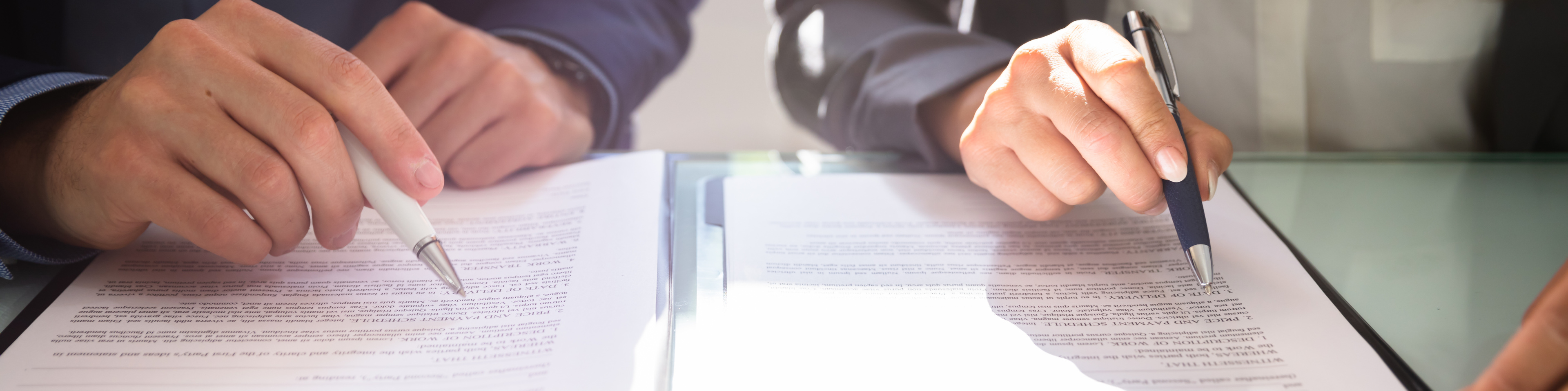 Two Businesspeople Working On Contract Paper