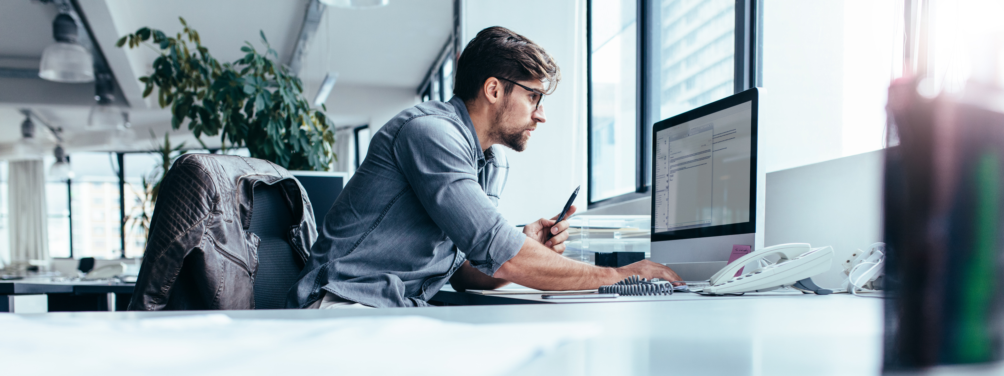 Young businessman in office working on computer