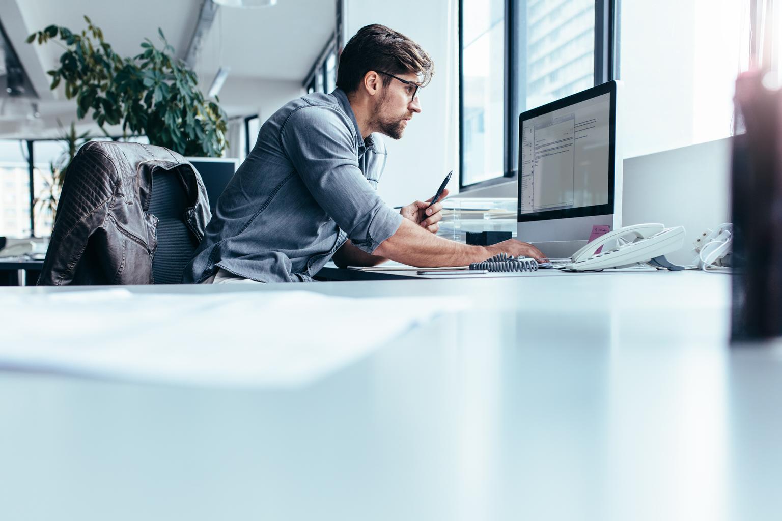 Young businessman in office working on computer