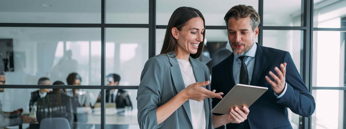 two people looking at a tablet hero image