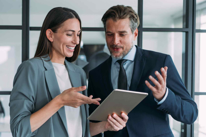 two people looking at a tablet hero image