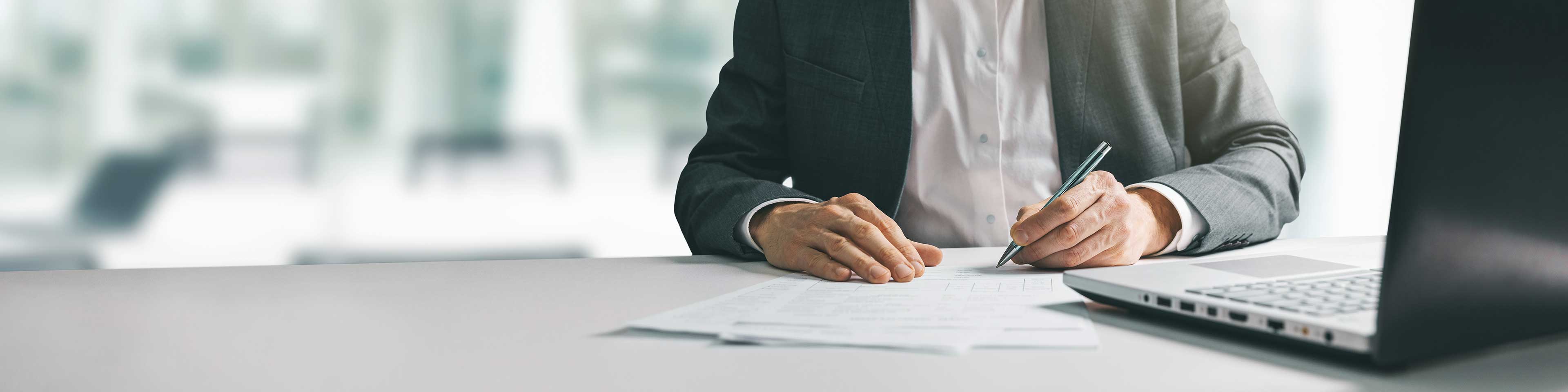 man signing documents