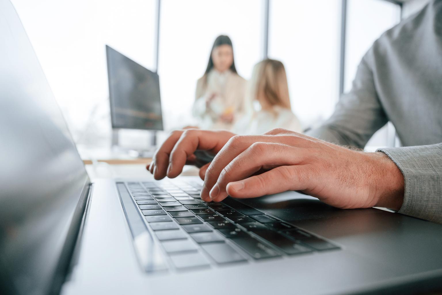 Close up view of using a laptop in the office