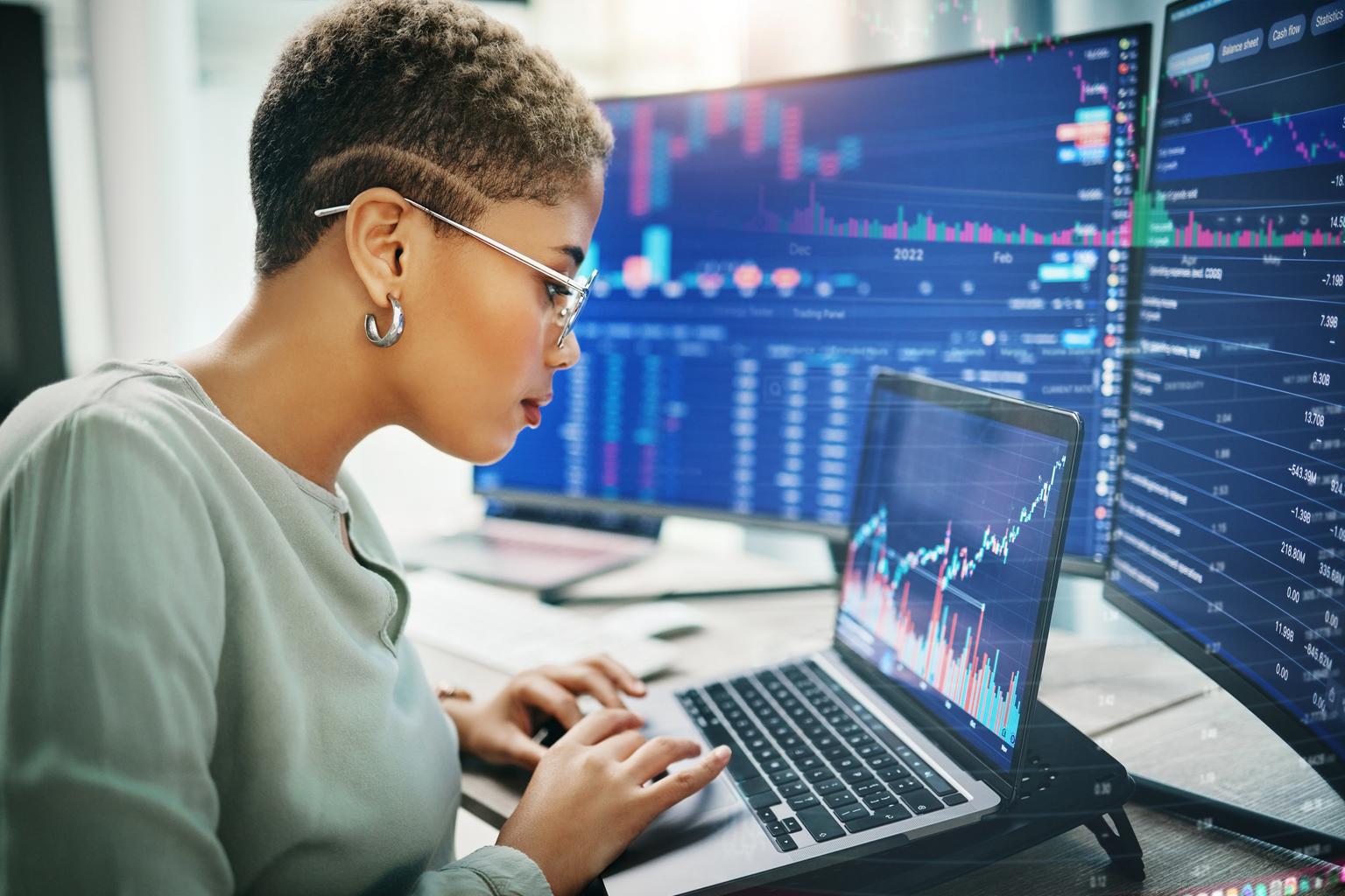 Woman working in office and looking at screens