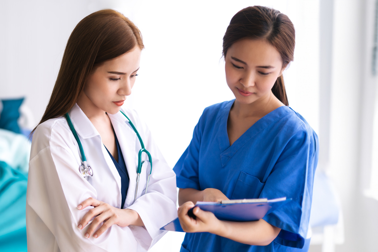 Asian Doctor discussing and examining in hospital room with patient rest on Hospital bed