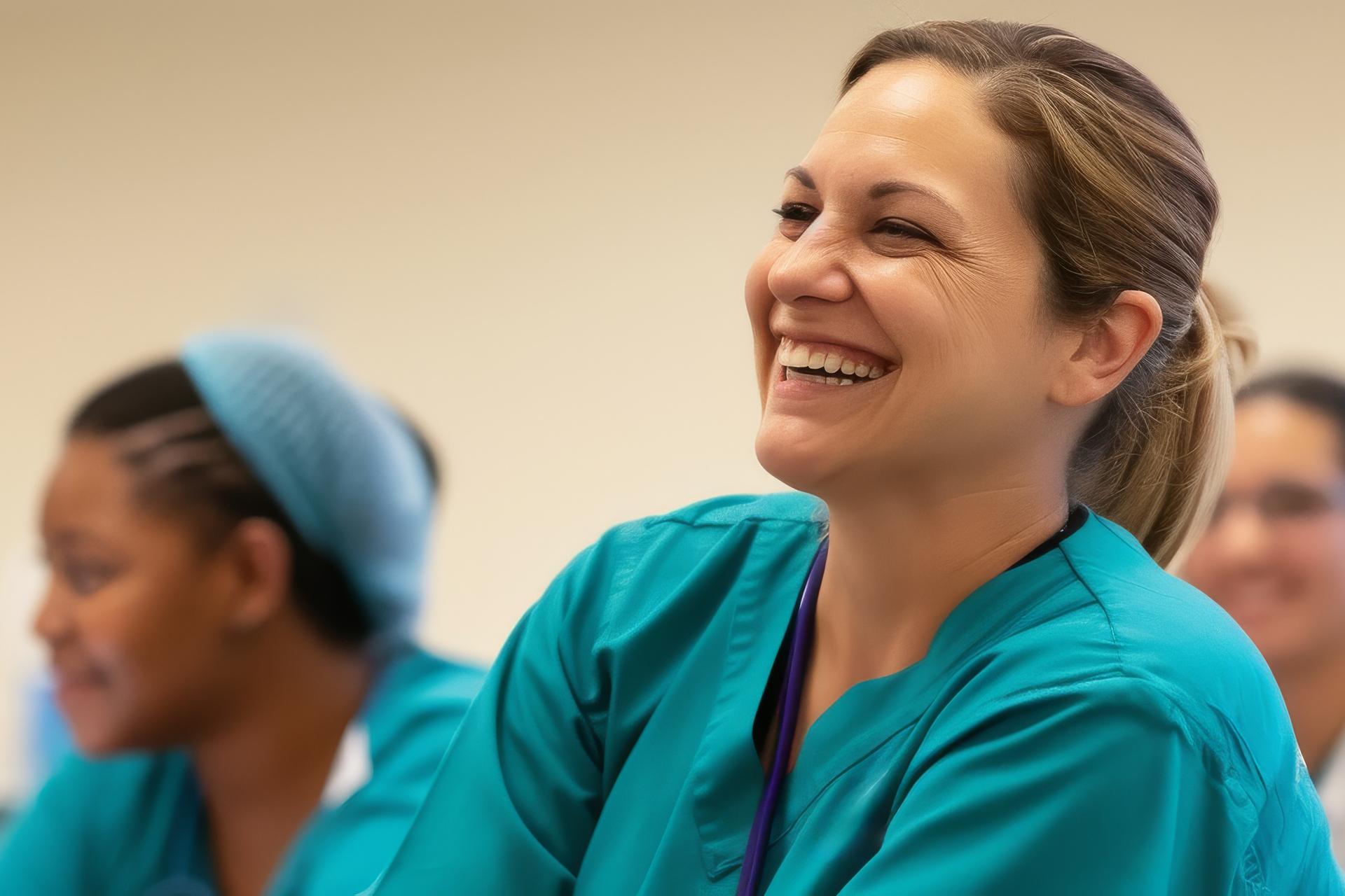 Nursing student smiling surrounded by other nursing students